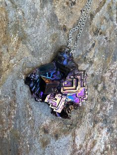 This pure bismuth crystal was created & shaped  myself on a silver plated copper chain and lobster claw closure. The chain length is 20 inches and the whole piece is 21 grams including the 1.7 gram chain. Bismuth naturally forms crystals when melted and cooled slowly. The rainbow coloring comes from natural oxidation the moment the crystal meets oxygen. Since the metal has such a low melting point (~520 F) it's fairly easy to create crystals right at home (with proper safety equipment). Bismuth Nickel Free Metal Crystal Necklace For Gifts, Iridescent Metal Necklace Gift, Metal Crystal Necklaces With Lobster Clasp As Gift, Bismuth Element, Bismuth Crystal Ring, Unique Iridescent Nickel-free Necklace, Handmade Mineral Crystal Amulet Necklace, Bismuth Jewelry, Nickel-free Metal Crystal Necklace For Gift