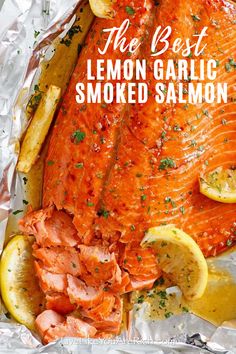 salmon and lemons on foil with the words honey garlic salmon overlaying it