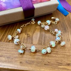 This one of a kind Ethiopian Opal bracelet is made with 14k Gold Filled Wire & luminous gemstones. Opals reflect beautiful flashes of color. Bracelet length is 8 1/2" with an adjustable extender. Opals vary in size - from 5mm wide to 1/4" wide Only one! Ships within 24 hours! Gold Opal Jewelry With Round Beads, Gold Briolette Bracelets With Natural Stones, Adjustable Gold Jewelry With Ethiopian Opal, Elegant Opal Beaded Bracelets With Round Beads, Elegant Opal Beaded Bracelets As Gift, Adjustable Gold Ethiopian Opal Jewelry, Elegant Ethiopian Opal Gemstone Beads Jewelry, Adjustable Opal Rondelle Jewelry, Hand-strung 14k Gold Bracelet