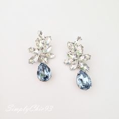 "Elegant Vintage style Bridal Earrings. Made with high-quality Crystal rhinestones in light blue and clear crystals. Gorgeous and elegant floral-inspired drops. Pair them with a cocktail dress or an over-sized sweater for an everyday look. Rhodium silver plated 2\" length, 1\" width Glass crystals Surgical steel posts, hypoallergenic" Blue Rhinestone Crystal Earrings For Wedding, Blue Statement Earrings, Blue Chandelier, Bridal Statement Earrings, Engagement Party Dresses, Crystal Cuff Bracelet, Clear Crystals, Large Crystals, Large Earrings