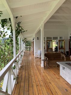 a porch with wooden floors and white walls