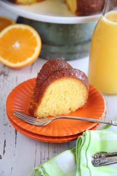 a slice of orange bundt cake on an orange plate with a fork next to it