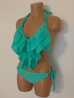 "Ruffle two piece swimsuit.Fully lined. Ruffle swimsuit top & adjustable tie side bikini scrunch bottom. These ruffles will naturally fall to your navel. Below is my standard size chart. If you prefer to have your suit custom made to your measurements please use the personalization option and leave your bra size, waist and hip measurements. Size chart- Extra small Bust - 28\" - 30\" AA cup Hips - 29\" - 32\" Waist - 22\" - 24\" Small Bust - 28\" - 34\" A & B cup Hips - 32\" - 36\" Waist Vacation Swimwear With Ruffles And Tie-side Bottom, Summer Halter Neck Swimwear With Ruffles, Summer Ruffled Halter Neck Swimwear, Halter Neck Ruffled Swimwear For Summer, Beachwear Tankini With Ruffles For Pool, Ruffled Halter Neck Swimwear For The Beach, Halter Neck Swimwear With Ruffles For Beach, Halter Neck Ruffled Swimwear For Beach, Summer Stretch Tankini With Ruffles