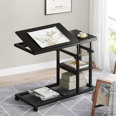 a black table with some books on top of it and a chair in the background