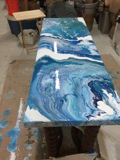 a table that has some kind of blue and white paint on it