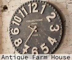 an antique farm house clock hanging on the side of a brick wall with text overlaying it