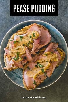 a plate filled with ham and cheese on top of a blue table cloth next to a knife