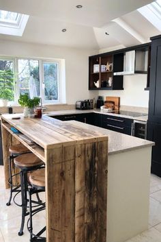 a kitchen with an island made out of wooden planks