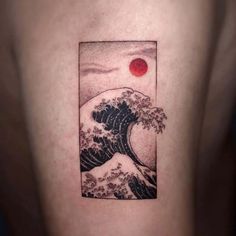 the great wave tattoo on the back of a man's left arm is shown