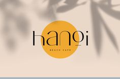 the logo for hamoi beach cafe is shown on a blurry background with palm leaves