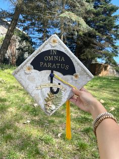 someone is holding up a graduation cap that says in omnia paratus on it