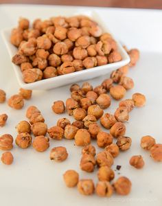 a white bowl filled with nuts on top of a table