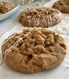 several cookies with icing on them sitting on a table