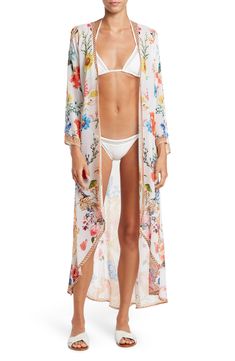 Vivacious floral printing blooms across a lightweight, duster cover-up featuring dramatic kimono sleeves for an ultra chic, post-swim look. 52" length Open front Kimono sleeves 100% polyester Dry clean Imported Model stats: 5'10" height, 32" bust, 25" waist, 36" hip. Model is wearing size One Size. Open Front Kimono, Long Duster, Floral Printing, Kimono Sleeves, Swimwear Cover Ups, Kimono Sleeve, Curator Style, Kimono Top, Cover Up