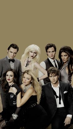 the cast of gossip magazine posing for a photo in front of a brown background with black and white accents