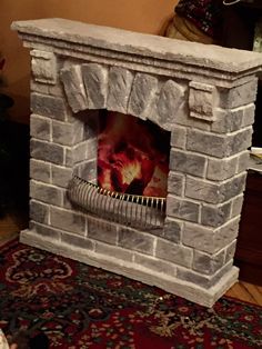 a fire place with a fan on top of it