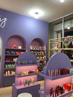 the interior of a beauty store with purple walls