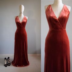 a red velvet dress on display next to a pair of black high - heeled shoes