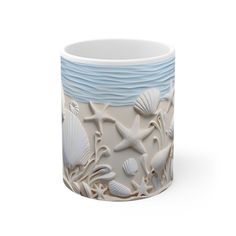 a ceramic mug with shells and starfishs on it