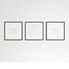 three square paintings hang on the wall