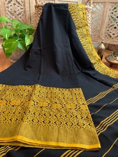 This is an original Begampuri cotton saree in a striking black and mustard yellow combination. Simple, comfortable and elegant are the right three words to describe this six yards. This saree is named after the town it is woven in- Begampur is a small town famous for its saree weaving in the Hooghly district of West Bengal. These sarees can be identified by their loosely woven, light-weight and translucent make and have contrasting borders in red, black, purple, orange etc. Weavers use a pit loo Yellow Cotton Traditional Wear With Patterns, Yellow Cotton Handloom Traditional Wear, Black Chanderi Dupatta With Weaving Work, Black Saree With Woven Motifs For Festivals, Yellow Cotton Dupatta With Weaving Work, Black Dupatta With Woven Motifs For Diwali, Festive Black Dupatta With Weaving Work, Black Saree With Woven Motifs For Diwali, Black Traditional Wear With Woven Motifs For Diwali