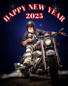 a man riding on the back of a motorcycle in front of a happy new year sign