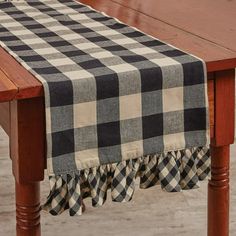 a black and white checkered table runner on a wooden table