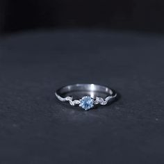 an engagement ring with two blue stones on it