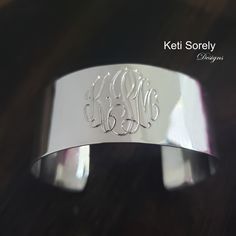 "Large cuff bracelet with etched monogram initials in the precious metal of your choice. Create personalized gift for your loved ones. Amazing jewelry for every day wear or special occasions. Designs by: Keti Sorely. Metal options: *Brass w/ yellow gold overlay *Brass w/ Rose gold overlay * Sterling Silver  * Sterling Silver with yellow gold overlay * Sterling Silver with Rose gold overlay Bangle width - 1\" Choose bangle sizes: Small (6-6.5\"),  Medium (7-7.5\")  Large (8-8.5\"). 1 to 3 letters Classic Personalized Initials Bracelet, Elegant Stamped Cuff Bracelet, Elegant Monogram Name Bracelet As Personalized Gift, Elegant Monogram Name Bracelet For Personalized Gift, Elegant Engraved Stainless Steel Cuff Bracelet, Elegant Monogrammed Name Bracelet For Personalized Gift, Modern Adjustable Jewelry With Monogram, Modern Adjustable Monogram Jewelry, Elegant Hand Stamped Sterling Silver Name Bracelet