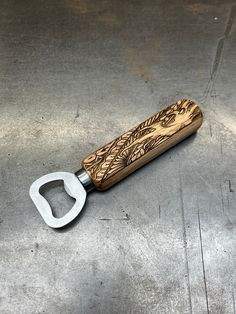 a bottle opener sitting on top of a metal surface