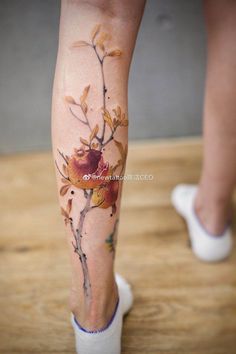 a woman's leg with flowers painted on it