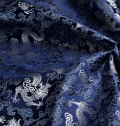 a blue and white fabric with dragon designs on the front, as well as an image of