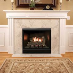 a fire place in a living room with a painting on the wall and a rug