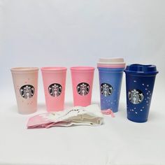 five starbucks cups are lined up next to each other