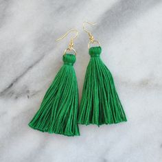 These green tassel earrings will make a big style impact, whether you're wearing them with jeans and a t-shirt or with a dress. At less than one-tenth of an ounce, Libby & Smee statement earrings feel virtually weightless! + super lightweight cotton tassel in emerald green + gold-plated OR silver-plated stainless steel ear wire hooks (lead-free and nickel-free) + comes with plastic earring back for security + LONG is 3.25 inches and MINI is 2.5 inches from the top of the ear wire     (each piece is handmade so lengths are approximate) + packaged on a hand-stamped kraft earring card in a clear resealing bag making them ready for gift giving MORE COLORS Order tassel earrings in 25 different colors: http://etsy.me/2urMOdW FREE DOMESTIC SHIPPING ABOUT THE MAKER  Hi! I'm Sue. :) Every Libby & S St Patricks Day Earrings, Snow Earrings, Yellow Tassel Earrings, Green Tassel Earrings, Red Garnet Earrings, Silver Crystal Earrings, Cobalt Blue Earrings, Winter Earrings, Plastic Earrings