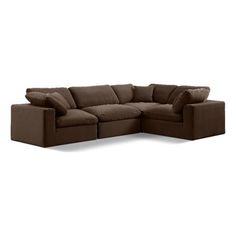 a brown sectional couch with pillows on it