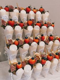 many cups with strawberries and other fruits in them