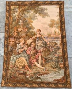 an old tapestry hanging on the wall in front of a stone wall with a woman and two children