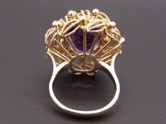 Jewelry Type: Ring Metal: 18k Yellow Gold Markings: 18k Measurements: 27mm x 24mm wide ( front face of ring) 3mm wide back of shank (most narrow area of band) 17mm high ( finger to top of ring) Weight: 15.1 grams Main Stone: Oval Cut Amethyst Gem Measurements: 17.7mm x 13mm x 11.7mm Gem Weight: 14ct total approx US Finger Size: 6 Video posted on our Instagram page @ CileoneJewelry #10358 Victorian Gold Oval Amethyst Ring, Gold Amethyst Cabochon Ring For Wedding, Art Nouveau Yellow Gold Rings For Formal Occasions, Gold Oval Art Nouveau Ring, Oval Hallmarked Flower Ring In Fine Jewelry Style, Formal Oval Flower Ring In Fine Jewelry Style, Luxury 14k Stamped Amethyst Wedding Ring, Victorian Yellow Gold Amethyst Ring For Formal Occasions, Oval Flower Ring For Formal Events