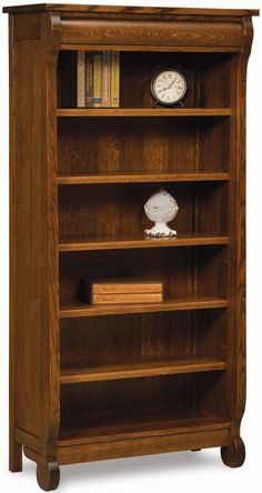 an oak bookcase with three shelves and two clocks