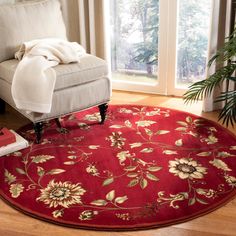 a living room with a red rug and chair