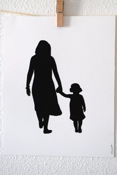 a black and white silhouette of a woman holding the hand of a child