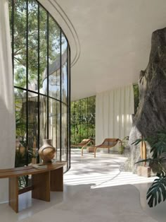 the interior of a modern house with glass walls and stone steps leading up to it