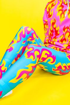 Flame Leggings in Blue, Pink & Yellow The hottest leggings ever!! The best-selling colourway of the Flame print is now available as super comfy stretchy leggings! They're made from high elastane lycra which gives them a sheen and makes them super stretchy for the perfect fit. As with all my prints, it's designed by me so you won't find these leggings anywhere else!  It's all in the details: -high-waisted leggings for a comfy fit -made from supersoft high-shine spandex -durable design -full lengt Blue Elastane Leggings For Spring, High Stretch Elastane Leggings For Summer, Bold Fitted Blue Bottoms, Blue Stretch Tights For Spring, Stretch Blue Tights For Spring, Trendy Blue Stretch Leggings, Summer Stretch Footless Leggings, Stretch Footless Leggings For Summer, Neon Carnival