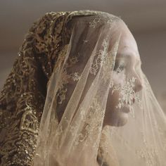 a woman wearing a veil with flowers on it