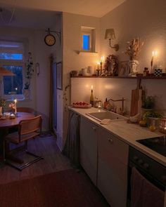 a kitchen filled with lots of counter top space next to a dining room table and chairs