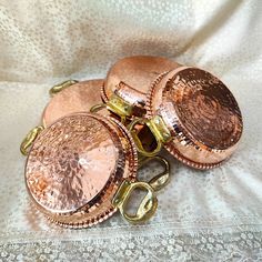 several copper colored metal objects on a white cloth