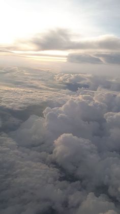 the view from an airplane looking down on clouds