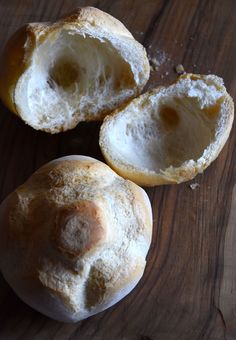 two loaves of bread sitting on top of a wooden table