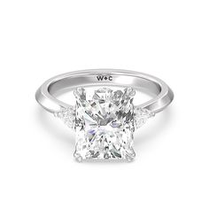 a cushion cut diamond ring with three side stones